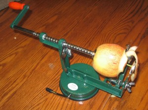Apple being peeled by a corer, peeler, slicer.
