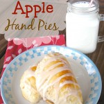 Baked Apple Hand Pies on a white plate with a glass of milk.