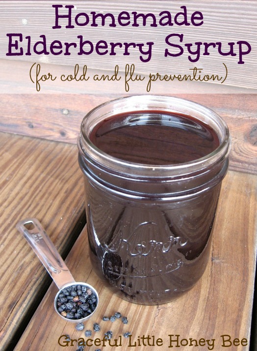 Elderberry syrup in Kerr jar on wooden board.