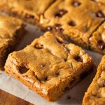 These Amish Chocolate Chip Cookie Bars are super easy to make and even easier to eat. Simply bake, slice and serve them for a fun chocolate treat!