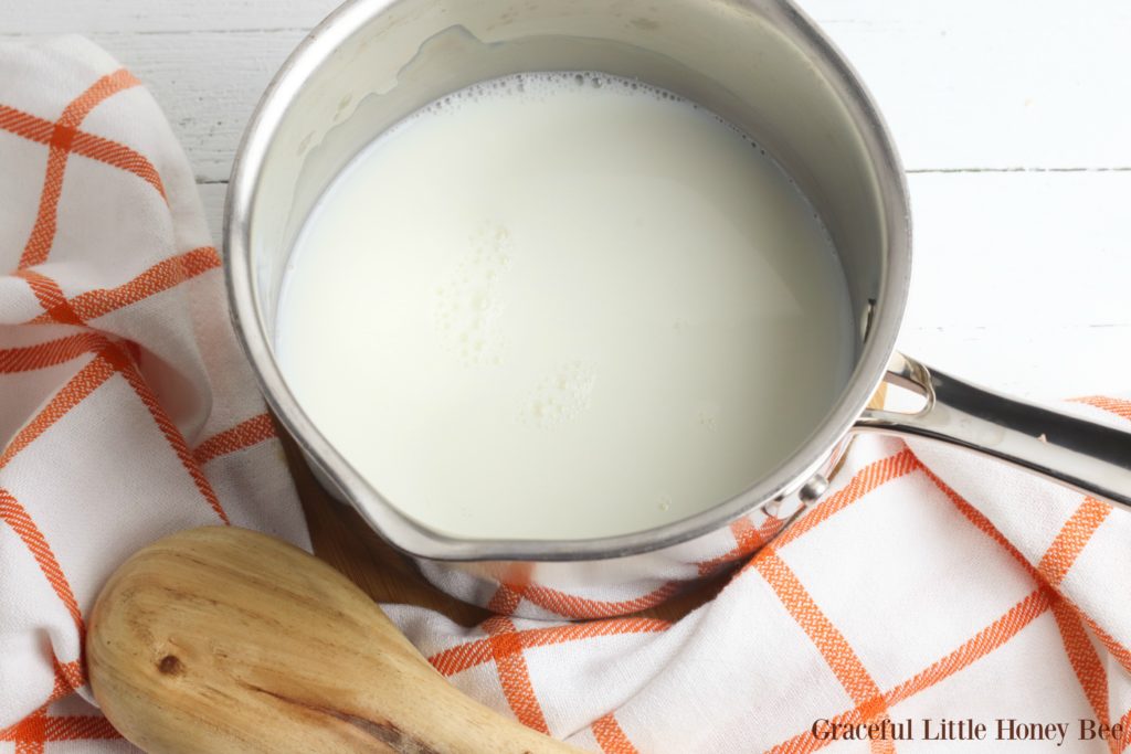 Milk in a silver pot.