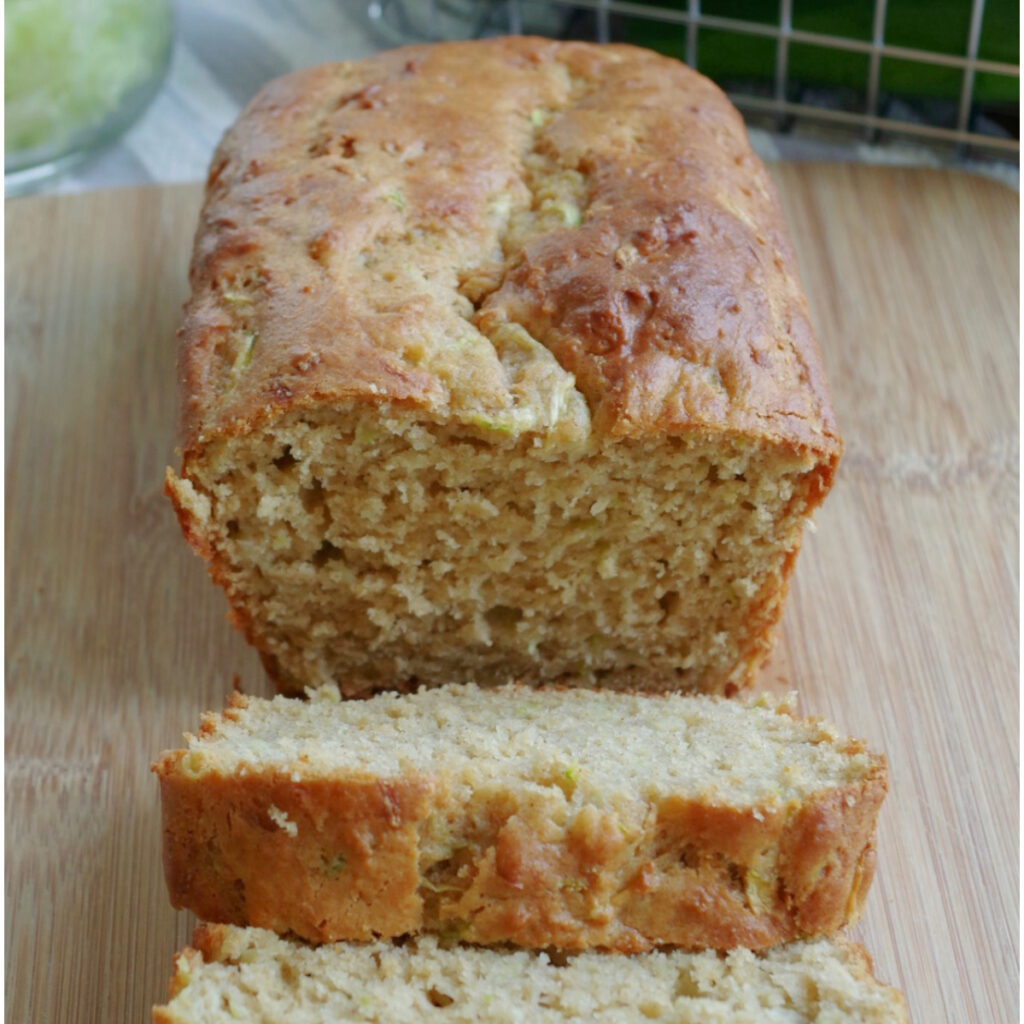 Greek Yogurt Zucchini Bread sliced on a cutting board.