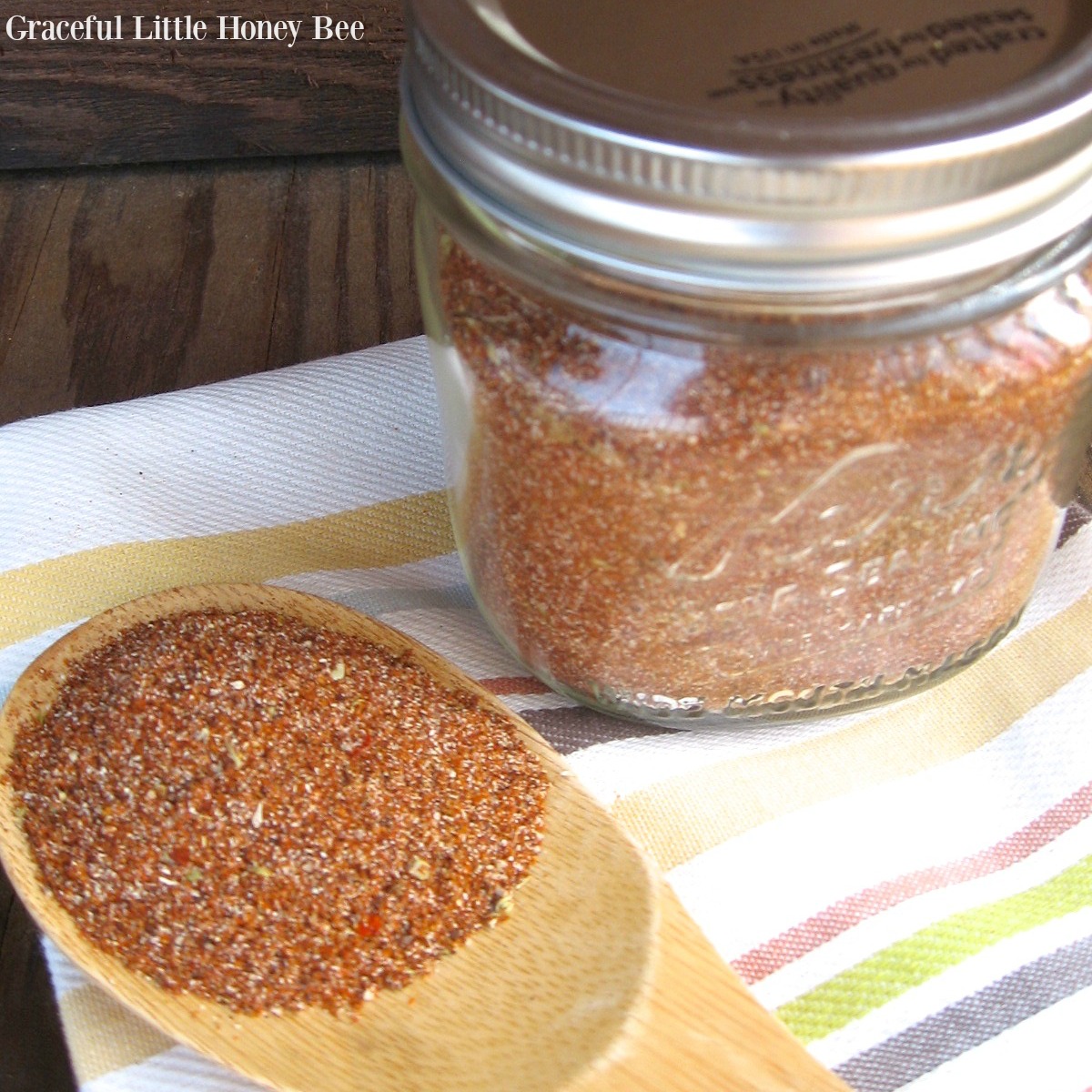 Homemade Taco Seasoning in a mason jar with a wooden spoon.