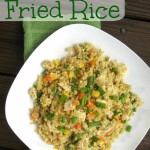 Quinoa Fried Rice on a white plate with a green towel in the background.