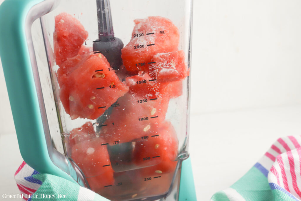 Frozen chunks of watermelon in a blender.