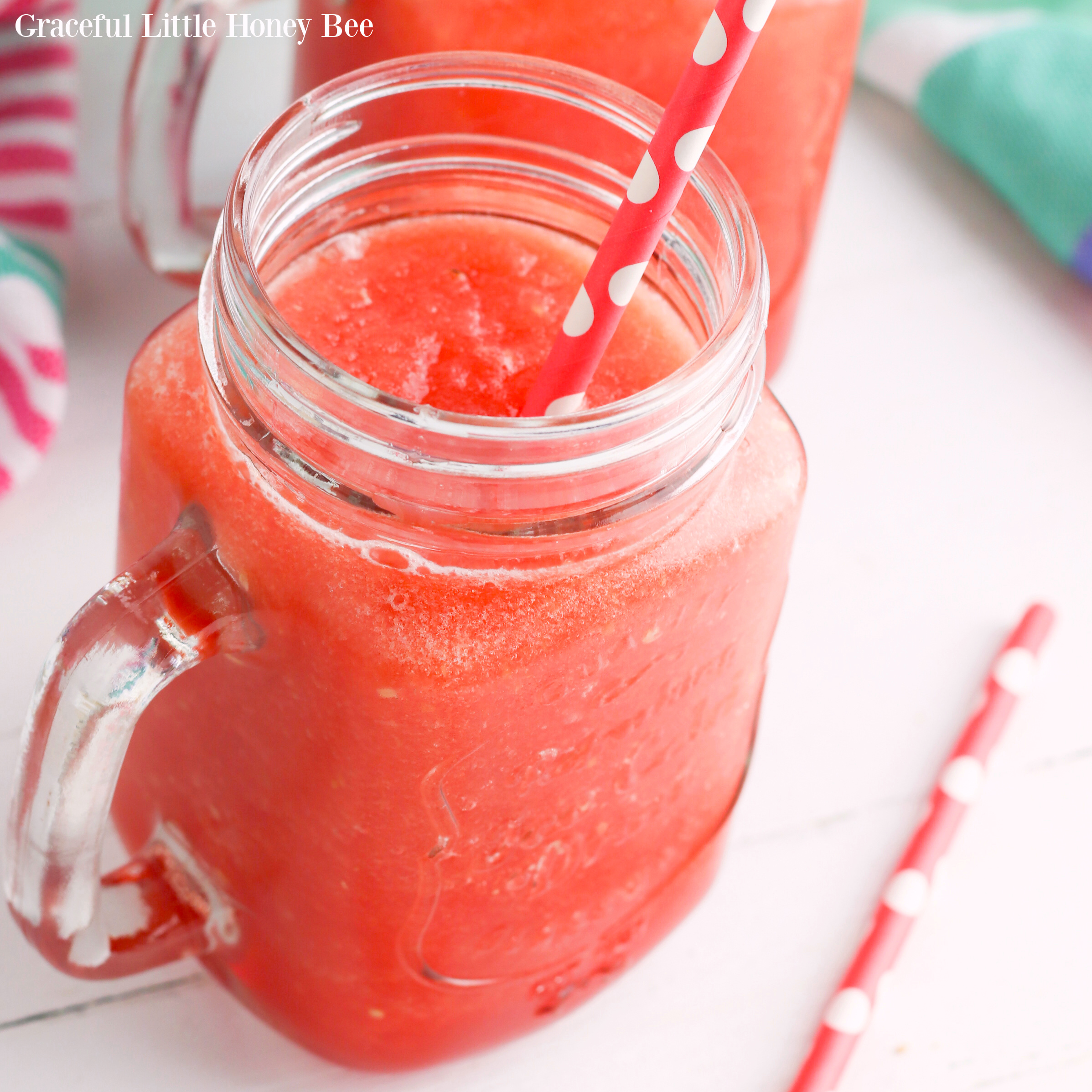 Watermelon slush in a mason jar with a straw.