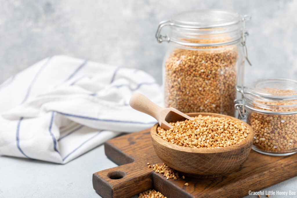 Bulk grain in jars and in a wooden bowl. 