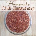 Homemade Chili Seasoning in mason jar on wooden cutting board.