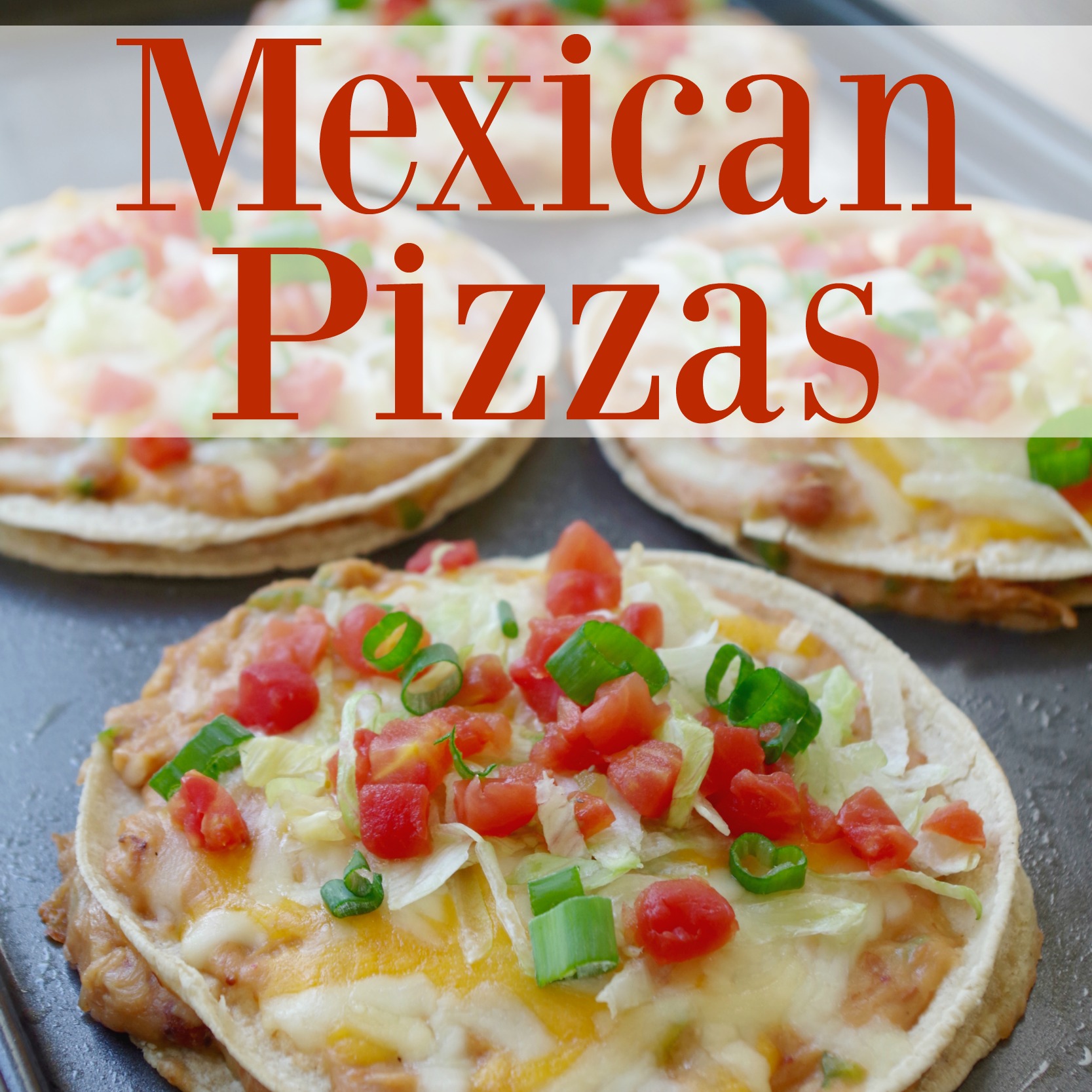 Homemade Mexican pizzas on a black cutting board.