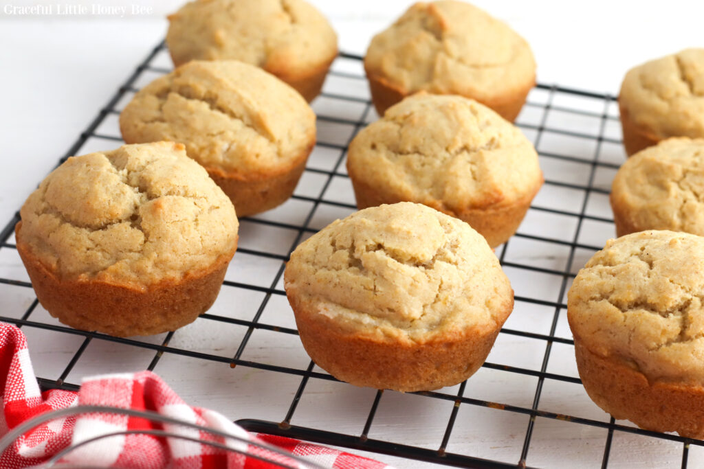 Applesauce muffins sitting on a wire cooling rack.