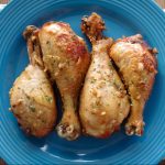 Chicken legs on a blue plate.