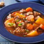 Homemade beef stew in a blue bowl.