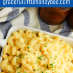 Macaroni and Cheese in a white square dish with a pressure cooker in the background.