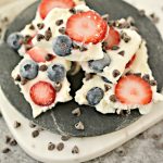 Greek Yogurt Chocolate Chip Berry Bark on a black plate.