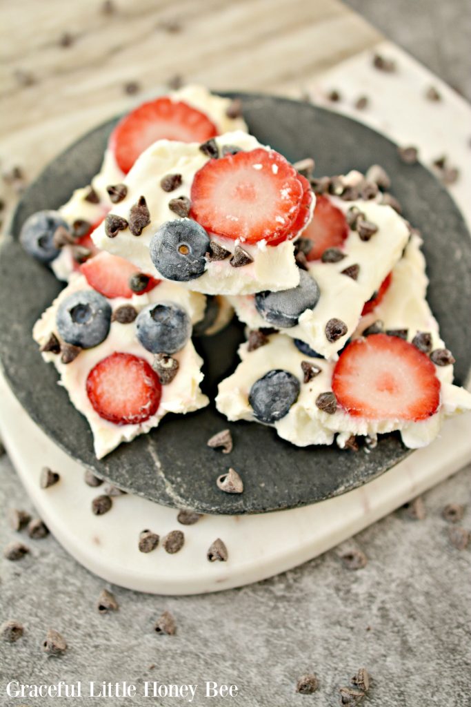 Greek Yogurt Chocolate Chip Berry Bark on a black plate. 