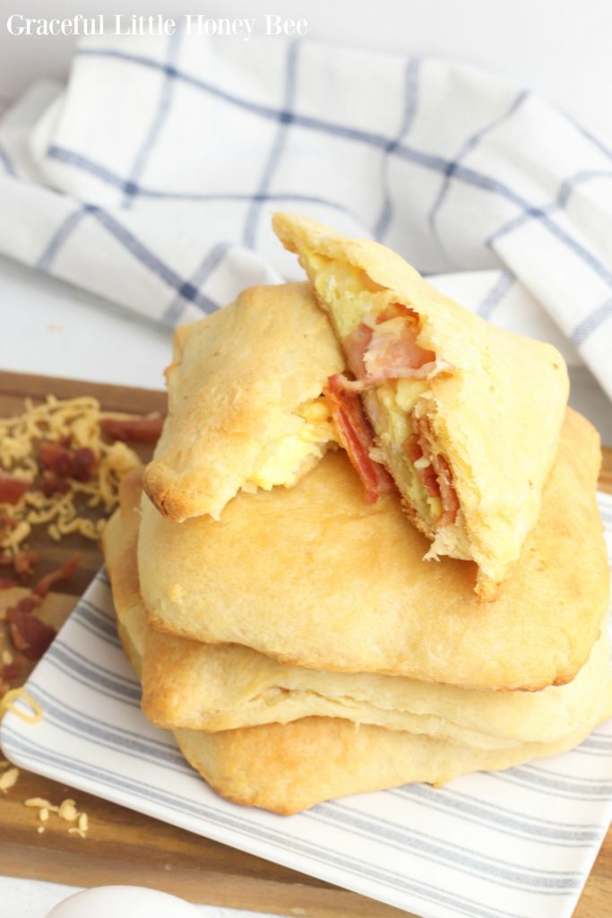 Bacon, Egg and Cheese Breakfast Pockets stacked on a plate.