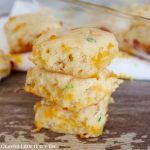 Three Cheddar and Green Onion Biscuits in a stack.