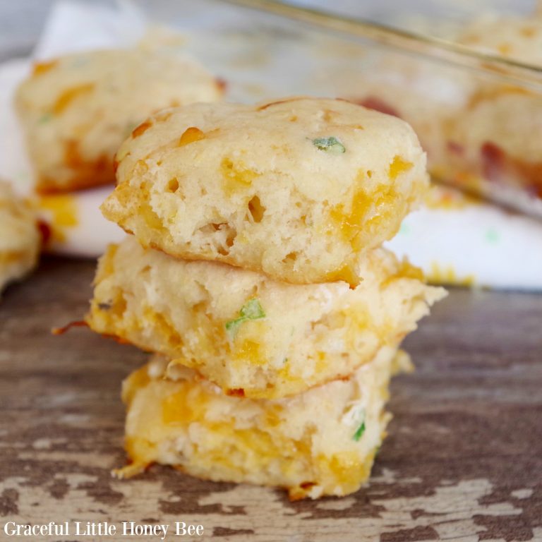Three Cheddar and Green Onion Biscuits in a stack.