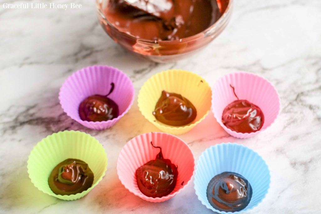 Chocolate spooned into silicone baking cups.