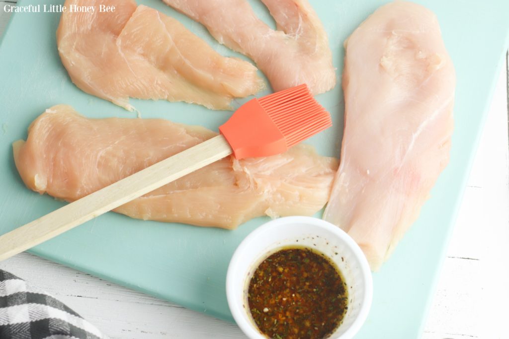 Raw chicken on a blue plate.