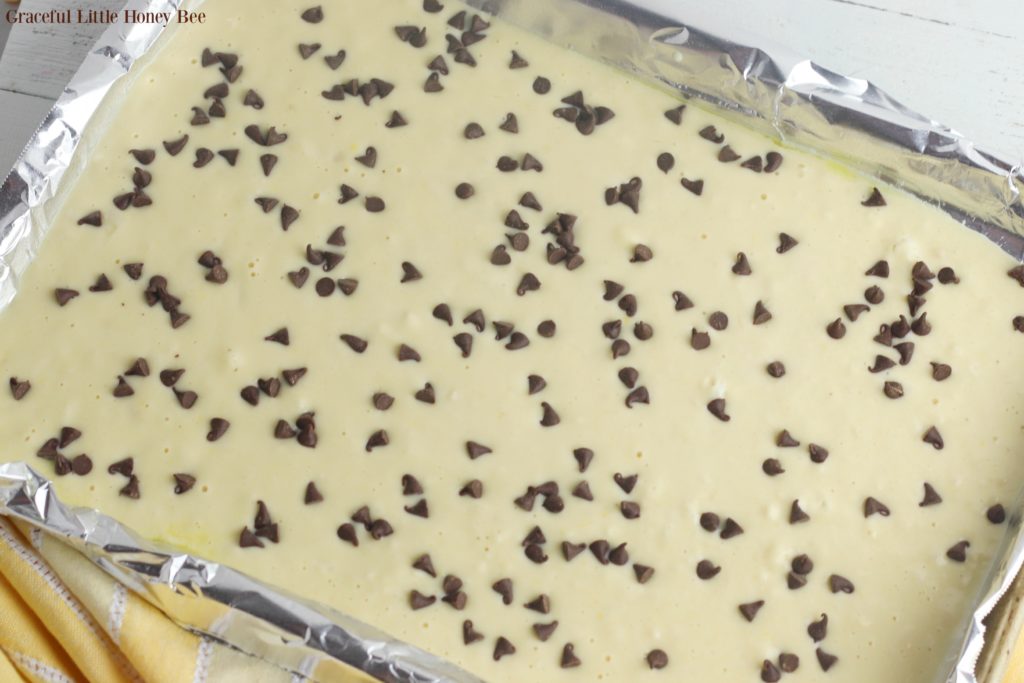 Pancake batter in pan sprinkled with chocolate chips.