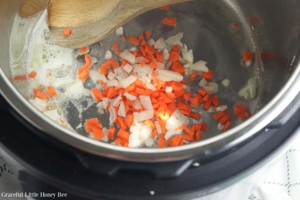 Onions and carrots sauteing in the Instant Pot.