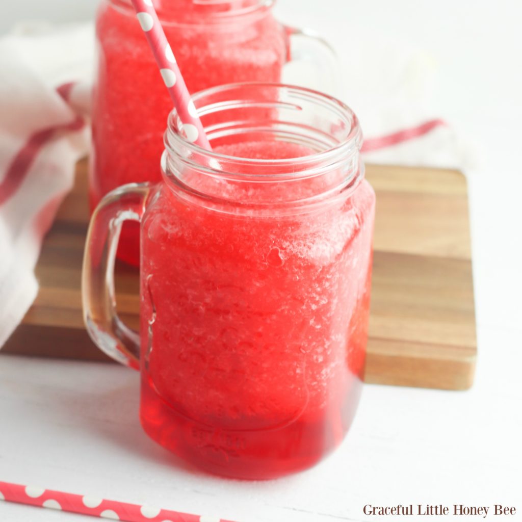 Finished slush in a mason jar with a polka dot straw.