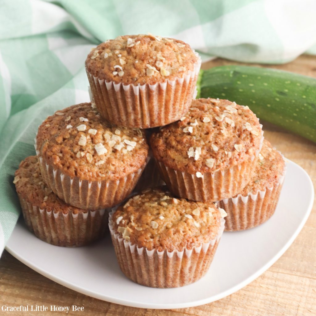 Finished muffins stacked on a white plate.