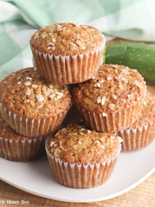 Finished muffins stacked on a white plate.