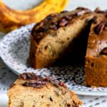 Slice of banana nut bread on a white plate.