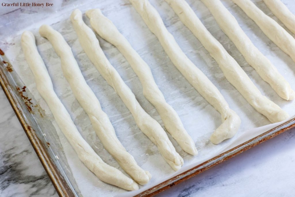 Long ropes of dough in a line.