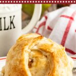 Apple Dumpling drizzled in lemon sauce on a white plate.