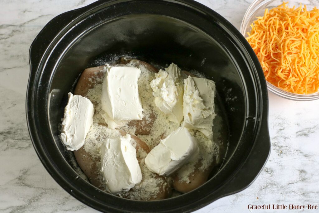 Chicken, cream cheese and ranch powder in a black crock-pot.