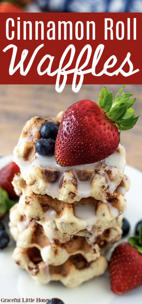 Cinnamon Roll Waffles stacked on a plate drizzled with glaze and topped with fresh fruit.