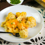 Ham & Cheese Cauliflower Casserole sitting on a white plate with a fork.