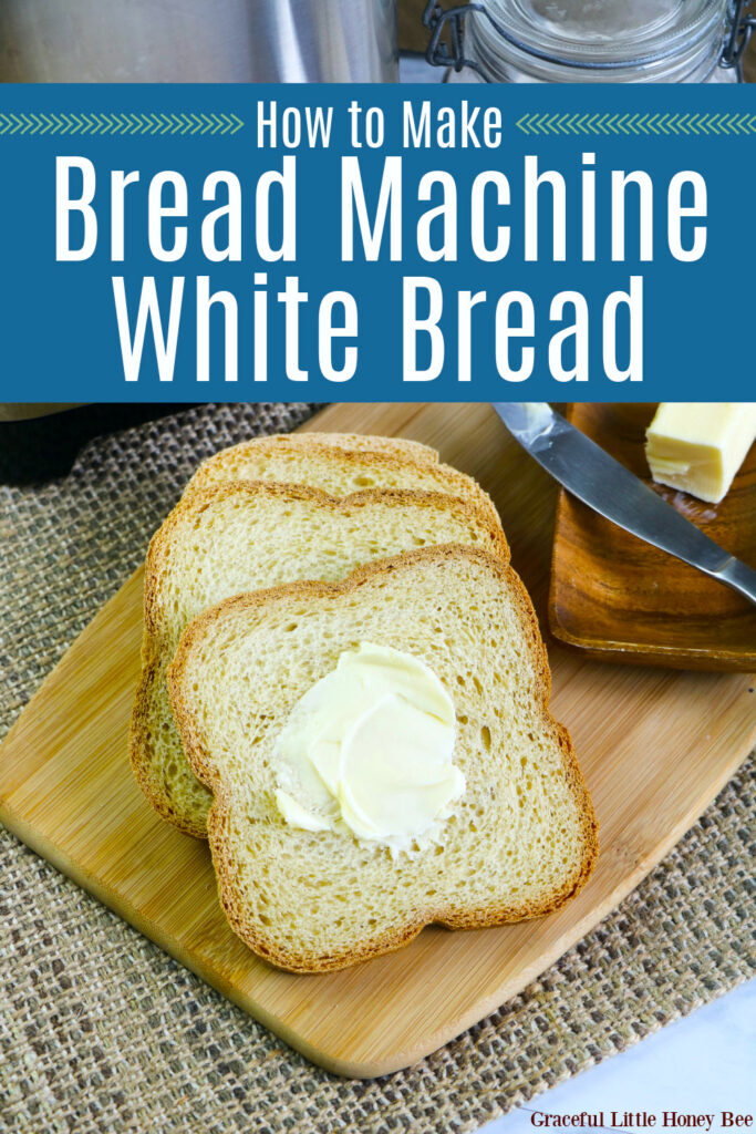 Three slices of fresh homemade bread spread with butter, sitting on a wooden cutting board.