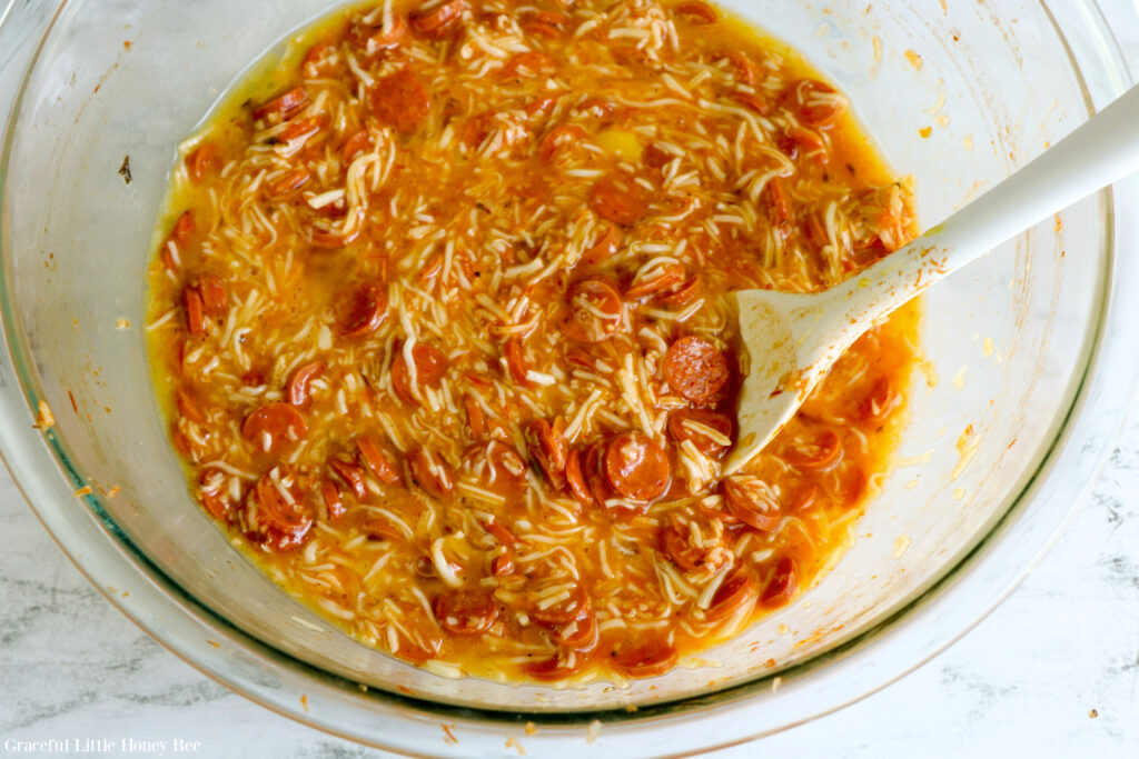 All casserole ingredients mixed in a glass bowl.