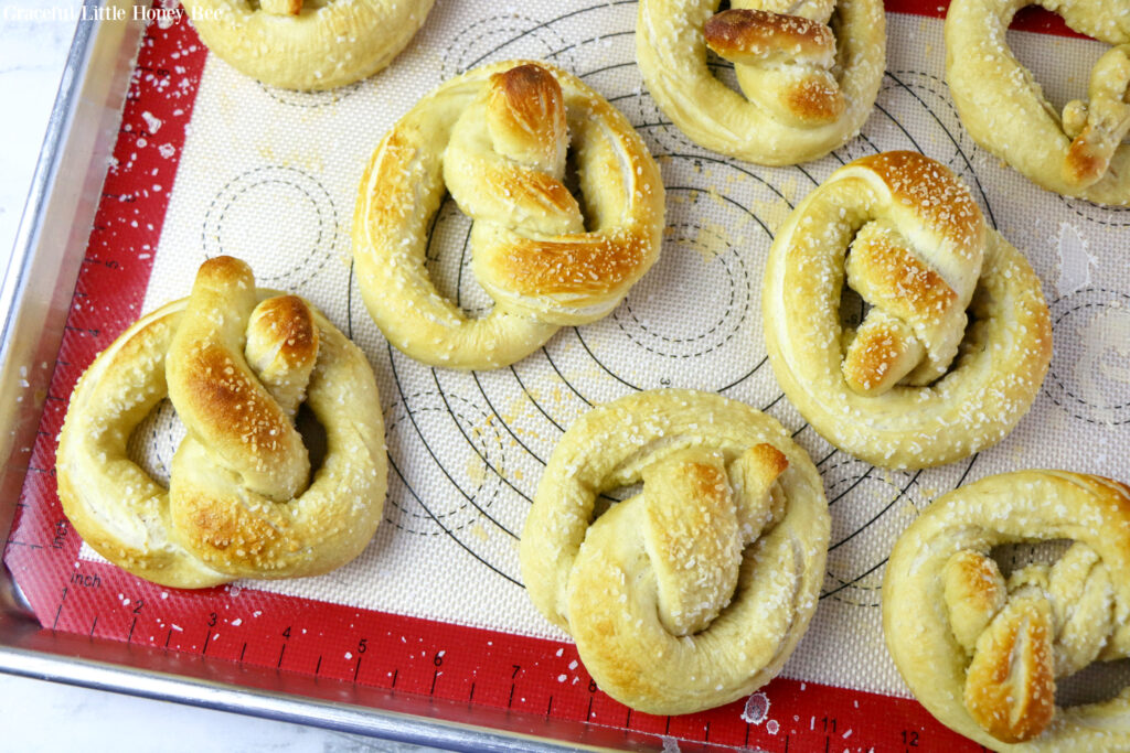 Baked pretzels sitting on a metal baking sheet.