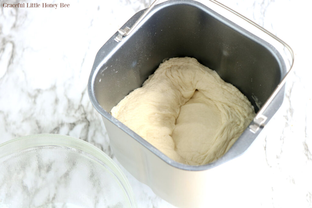 Pizza Dough in the bread machine pan.