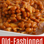 A white serving dish filled with brown sugar baked beans.