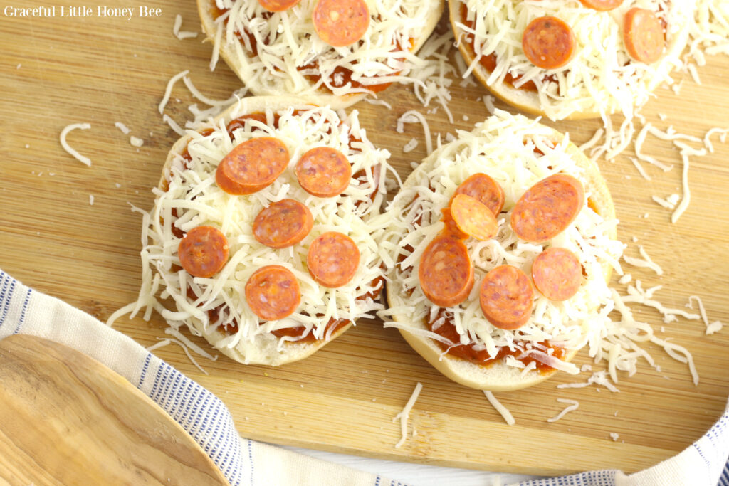 Bagels topped with sauce, cheese and pepperoni, before going into the air fryer.