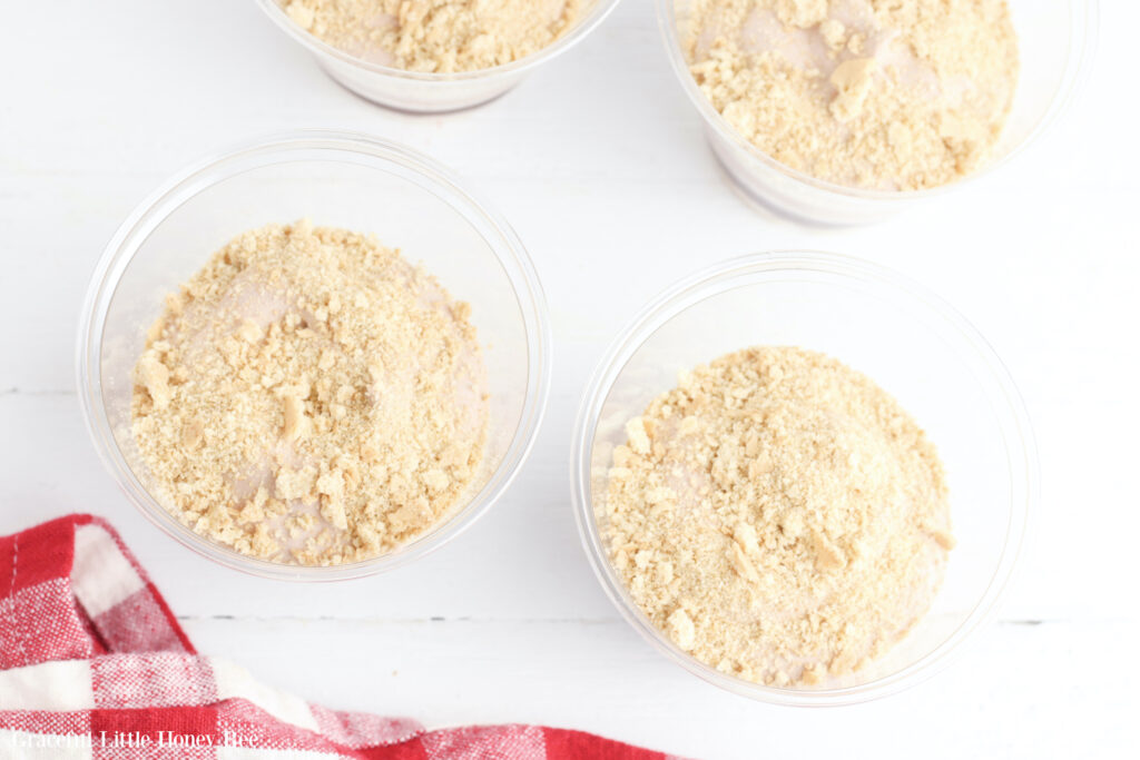 Another layer of graham cracker crumbs added to clear plastic cups.