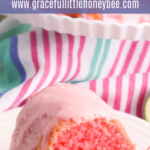 A slice of bundt cake garnished with a cherry on a small white plate.