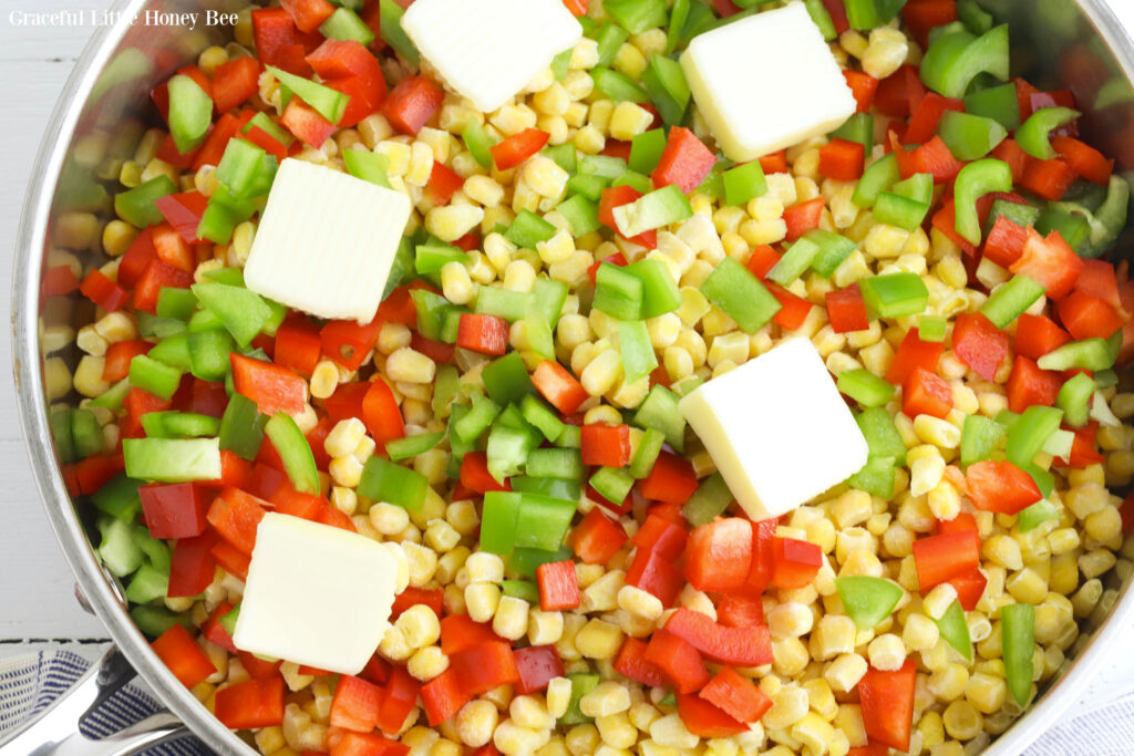 All ingredients for Fiesta Corn in a skillet before mixing and cooking.