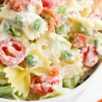 A close up shot of BLT Pasta Salad in a white bowl.