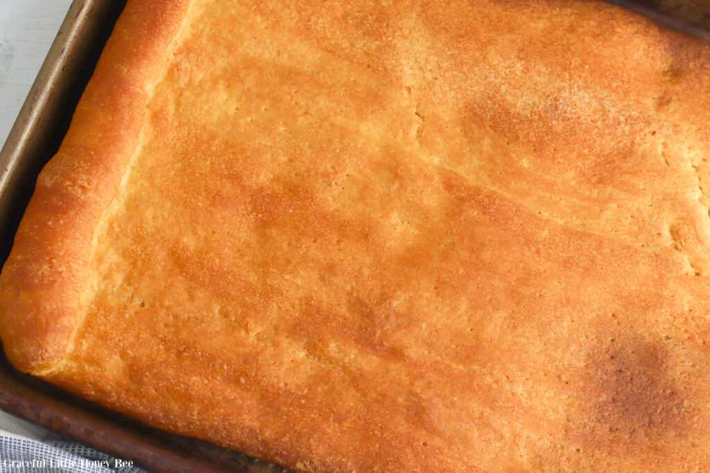 Baked crescent roll on a baking sheet.