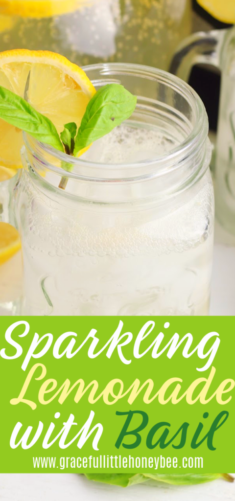 A mason jar full of Basil Sparkling Lemonade garnished with basil and a lemon slice.