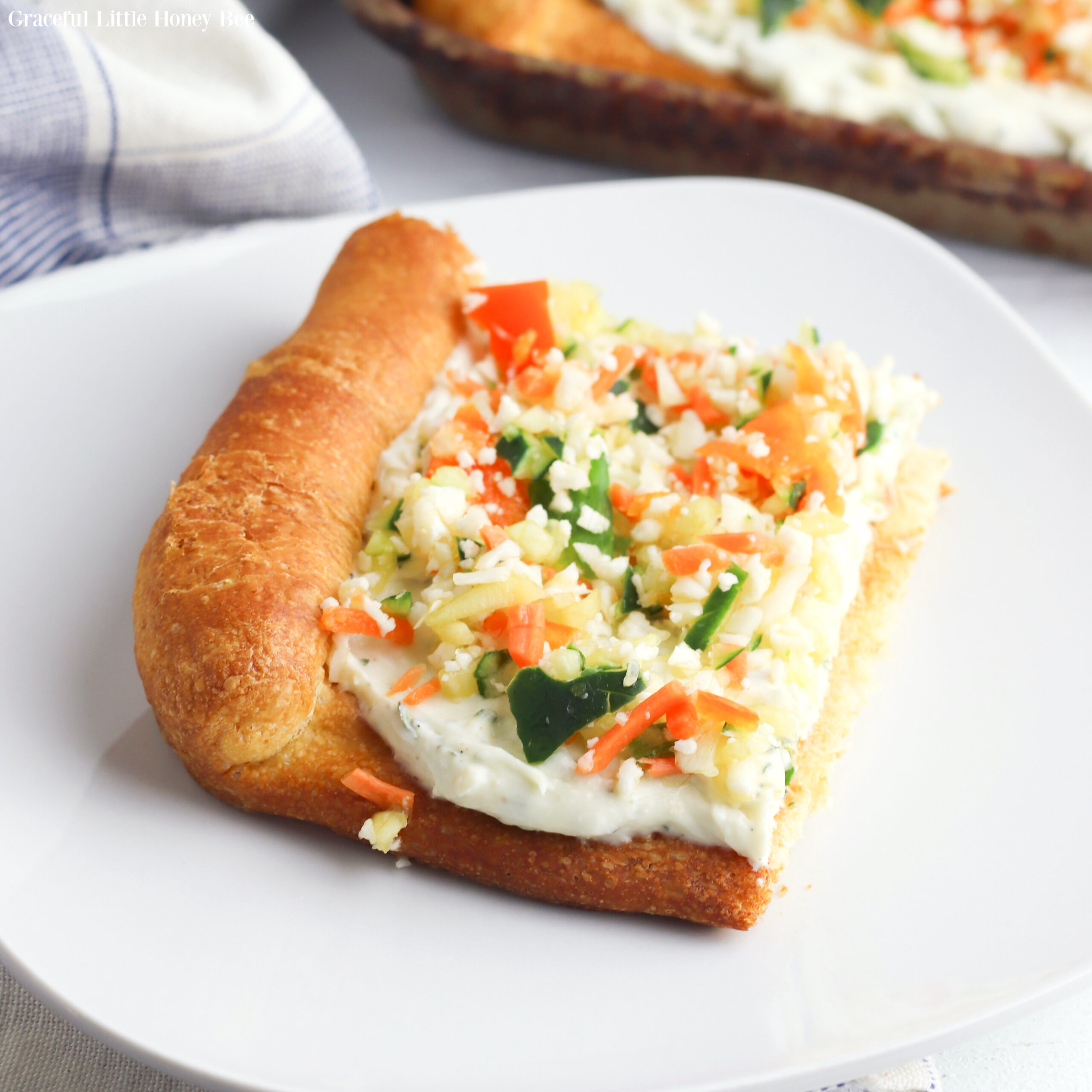 Slice of Veggie Pizza on a white plate.