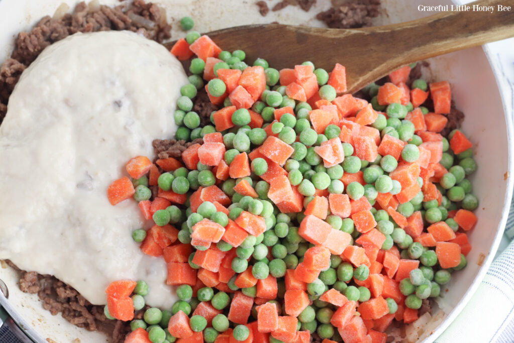 Ground beef, veggies and cream soup in mixing bowl.