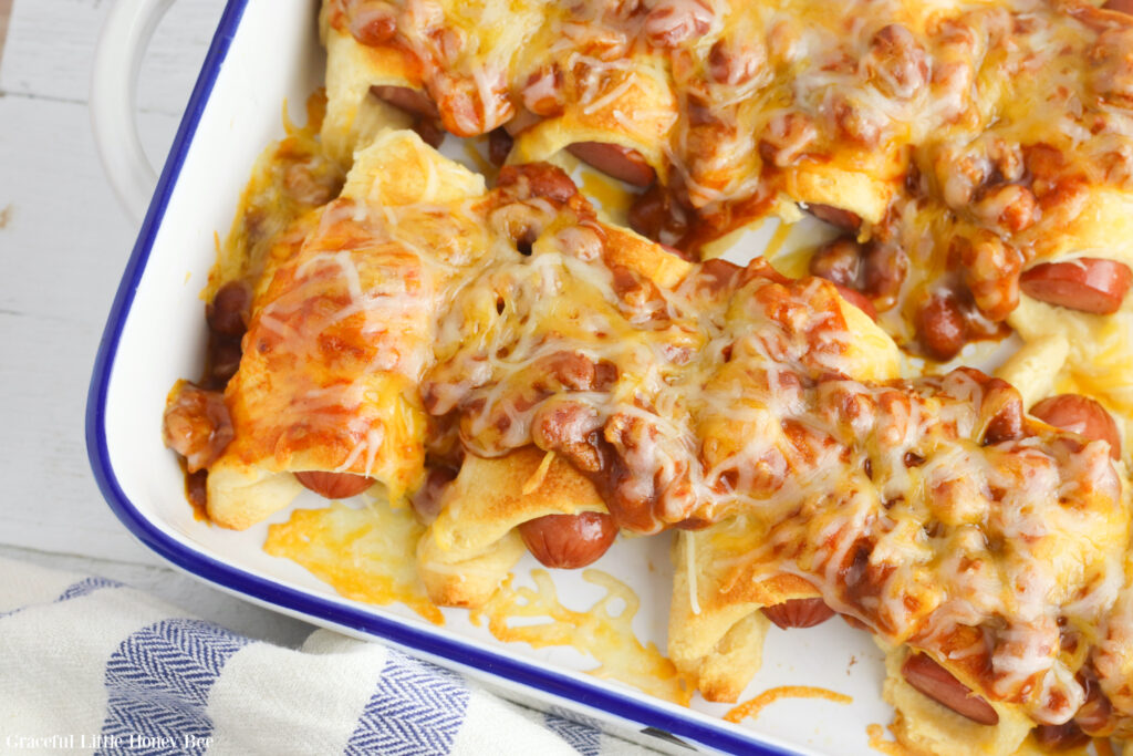 Chili Cheese Dog Casserole in a white enamelware casserole dish.